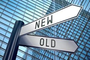 Old or New - Signpost With Two Arrows, Office Building in Background photo