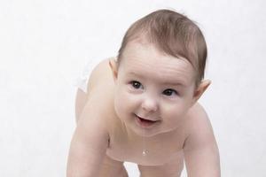 Six month old baby on a white background. Happy boy mid-range. Conceptual photo of fatherhood and motherhood.Alpha generation.