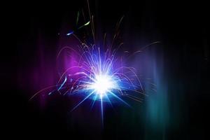 Flying bright sparks from welding on a dark background. photo