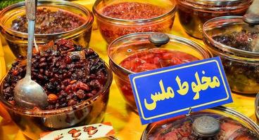 Piles of various colorful tasty candy sweets on bazaar for sale in iranian street market photo