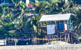 Puerto Escondido Oaxaca Mexico 2022 Beach watchtower with Mexican flag in Puerto Escondido Mexico. photo