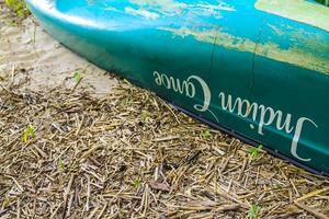 Harrier Sand Lower Saxony Germany 2010 Turquoise green canoe lies on bush on the beach Germany. photo