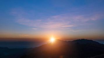 Beautiful sunrise landscape on the mountain of thailand. Golden and blue sky sunrise in the morning. photo