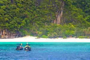 Koh Phi Phi Thailand with lagoon longtail boats limestone rocks. photo