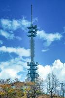 Telecommunications antenna tower for mobile phone with the blue sky background. photo