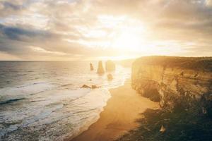 The Twelve Apostle in the great ocean road during the sunset, an iconic rock formation of Victoria state of Australia. photo