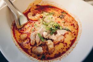 Tom Yum Goong mixed with meat ball noodles, Thai style and iconic popular taste of Thai foods. photo