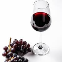 Red wine glass with red grapes - image photo