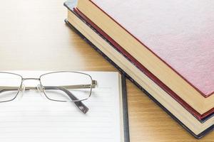 Eyeglasses and Notebook open blank page photo