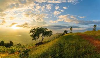 Mountain landscape with colorful vivid sunset on the cloudy sk photo