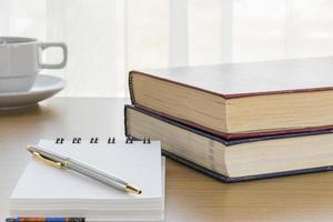 Pen put on notepad open blank page photo