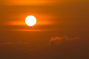 Sunrise over clouds with bright yellow sun on a morning photo