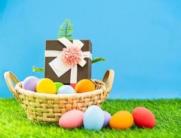 Easter eggs in the basket on green grass photo