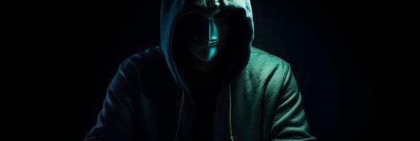 Unveiling the Enigmatic World of Cybercrime. A White Masked Hacker's Front View Amidst Dark Hood and Green Matrix Code Background photo