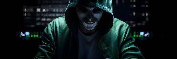 Unveiling the Enigmatic World of Cybercrime. A White Masked Hacker's Front View Amidst Dark Hood and Green Matrix Code Background photo