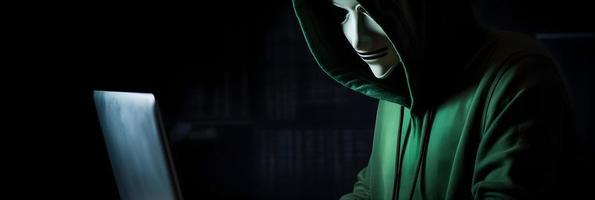 Unveiling the Enigmatic World of Cybercrime. A White Masked Hacker's Front View Amidst Dark Hood and Green Matrix Code Background photo