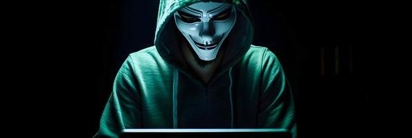Unveiling the Enigmatic World of Cybercrime. A White Masked Hacker's Front View Amidst Dark Hood and Green Matrix Code Background photo