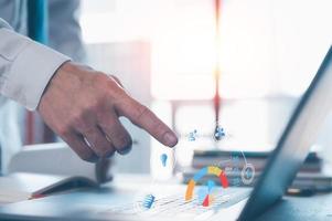 Analyst working with Business Analytics and Data Management System on computer, make a report with KPI and metrics connected to database. Corporate strategy for finance, operations, sales, marketing photo
