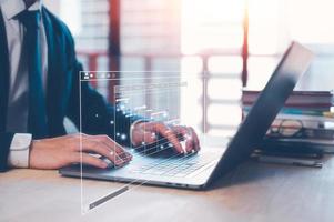 businessman, Analyst doing an Analytics and Data Management System on laptop computer, report with KPI and metrics database. Corporate strategy for finance, operations, sales, marketing. photo