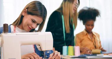 A group of young women are learning the profession of design and tailoring. photo