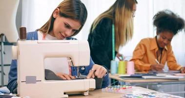 A group of young women are learning the profession of design and tailoring. photo