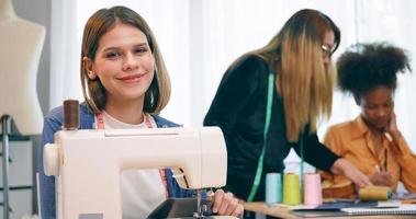 A group of young women are learning the profession of design and tailoring. photo