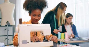 A group of young women are learning the profession of design and tailoring. photo