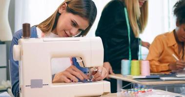 A group of young women are learning the profession of design and tailoring. photo