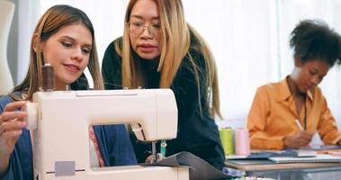 A group of young women are learning the profession of design and tailoring. photo