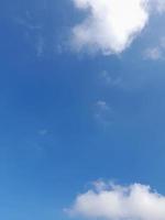 Beautiful white clouds on deep blue sky background. Large bright soft fluffy clouds are cover the entire blue sky. photo