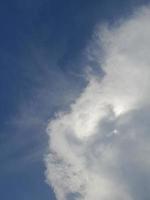 hermosas nubes blancas sobre fondo de cielo azul profundo. grandes nubes esponjosas suaves y brillantes cubren todo el cielo azul. foto