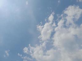 Beautiful white clouds on deep blue sky background. Large bright soft fluffy clouds are cover the entire blue sky. photo