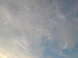 Beautiful white clouds on deep blue sky background. Large bright soft fluffy clouds are cover the entire blue sky. photo