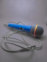 blue microphone with cable and grey background photo