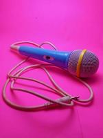 blue microphone with cable and grey background photo