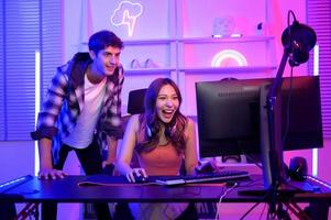 Young professionals  play video games together live streaming their matches  and speak with their fans at  homes. photo