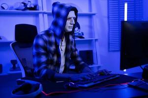 A Hacker is using laptop computer to steal data in the night photo