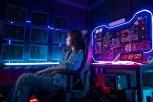 an asian woman programmer is working in her computer room , futuristic technology concept photo