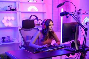 Young Asian Pretty woman Pro Gamer have live streaming , singing  and chatting  with her fans  at home photo