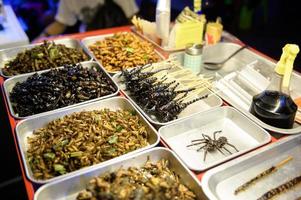 Exotic food in Khao San road at night in Bangkok city, Thailand, Holidays and traveling concept photo