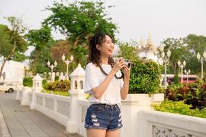 Beautiful young Asian tourist woman on vacation sightseeing and exploring Bangkok city, Thailand, Holidays and traveling concept photo