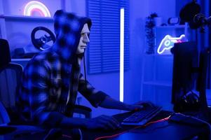 A Hacker is using laptop computer to steal data in the night photo