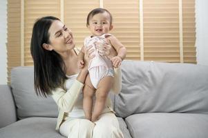 Portrait of mother and baby girl at home, family, child, childhood and parenthood concept photo