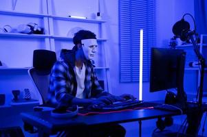A Hacker is using laptop computer to steal data in the night photo