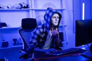 A Hacker is using laptop computer to steal data in the night photo