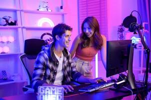 Young professionals  play video games together live streaming their matches  and speak with their fans at  homes. photo