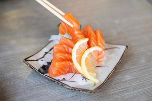 Salmon sashimi in Japanese style fresh serve on white plate. photo