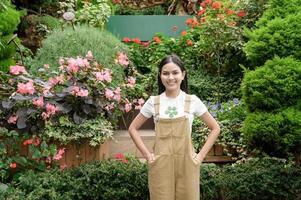 A young woman is smiling in her flower shop , small business concept. photo