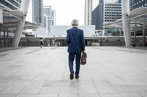 Portrait of Asian senior mature middle aged businessman in modern city photo