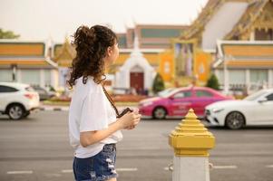 Beautiful young Asian tourist woman on vacation sightseeing and exploring Bangkok city, Thailand, Holidays and traveling concept photo